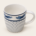 White ceramic mug with blue floral and dotted pattern