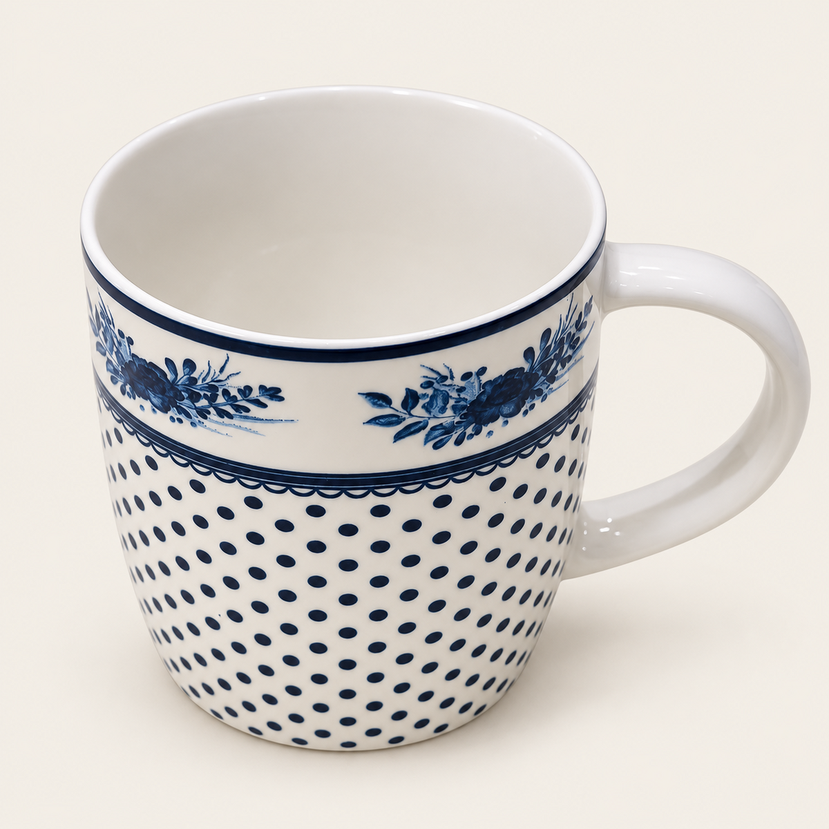 White ceramic mug with blue floral and dotted pattern