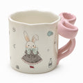 Ceramic mug with bunny illustration and pink bow-shaped handle