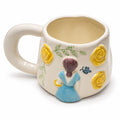 Cream ceramic mug with sculpted girl in blue dress and yellow flowers
