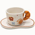 Gourmet Master ceramic cup and saucer with croissant-style handle