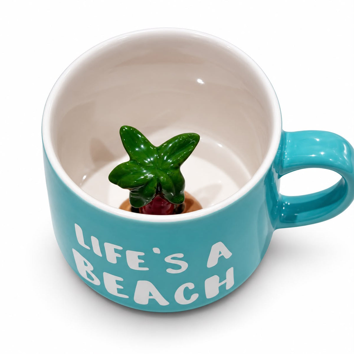Turquoise Life's a Beach ceramic mug with hidden palm tree figurine