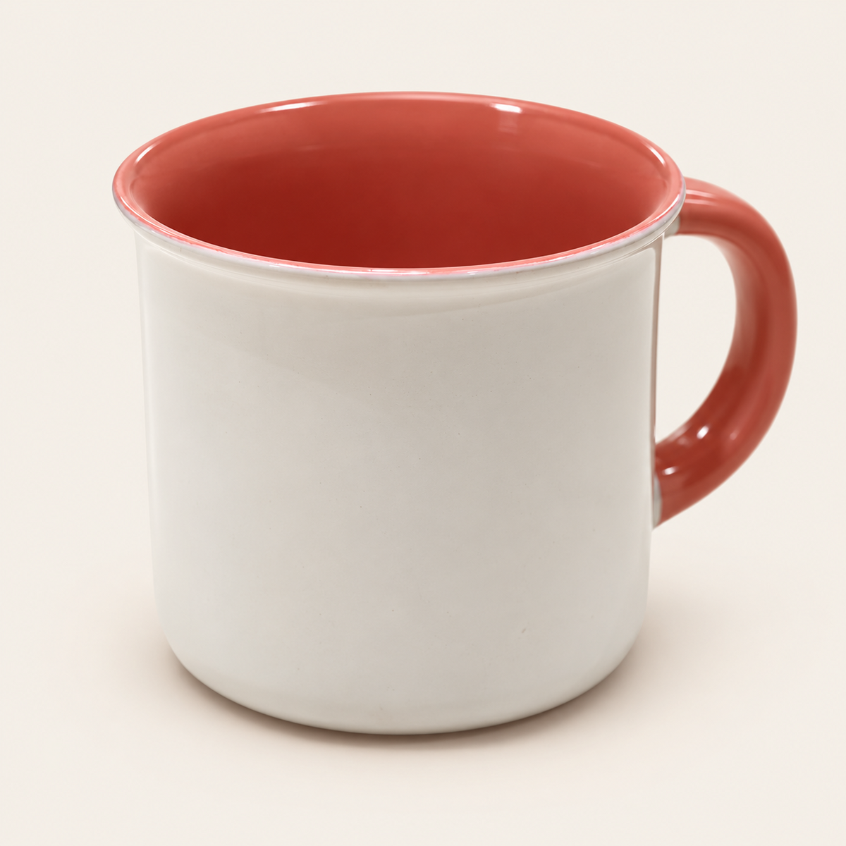 White ceramic mug with red interior and handle